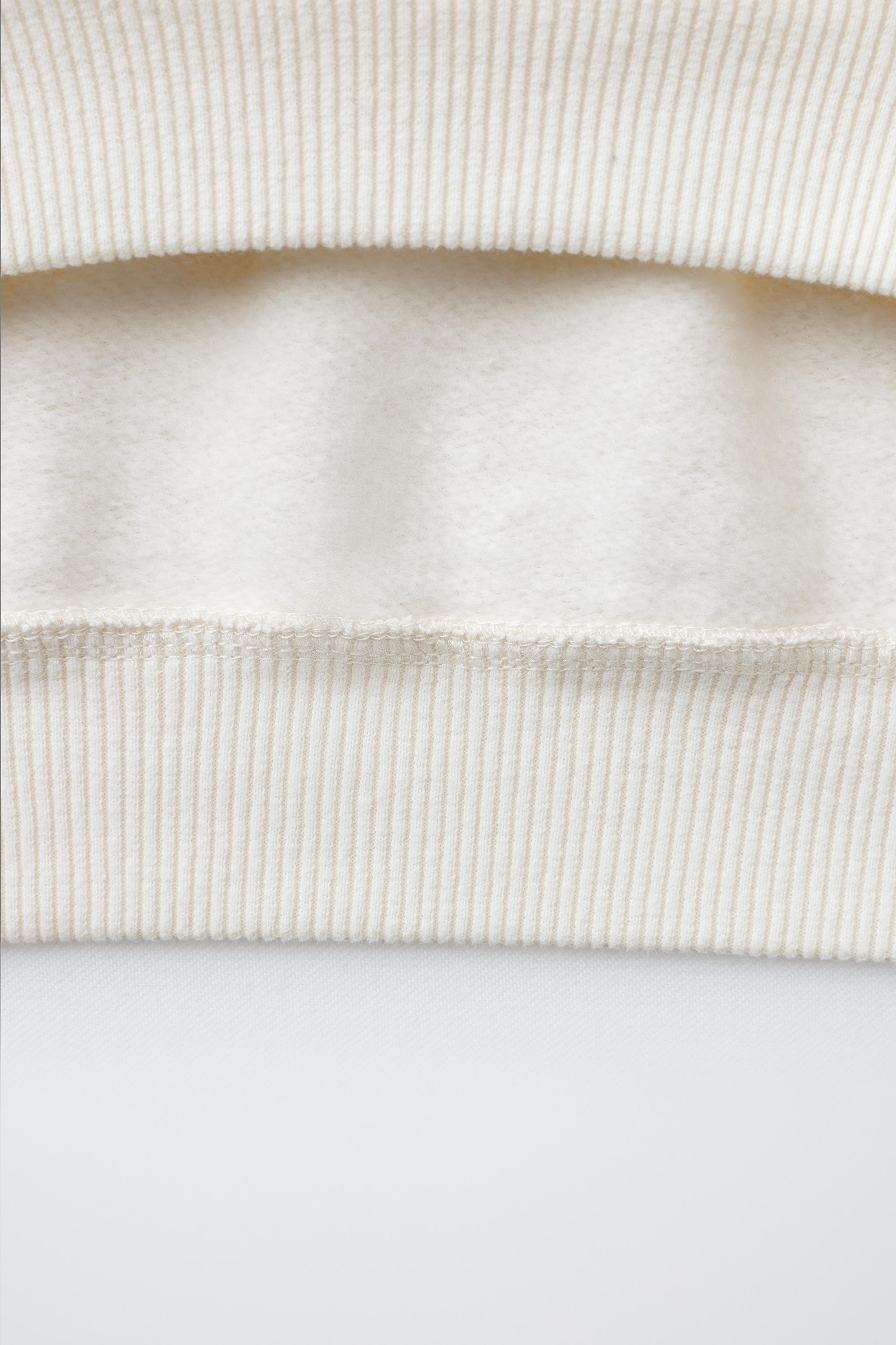 FAUX SHEARLING REINDEER PATCH SWEATSHIRT